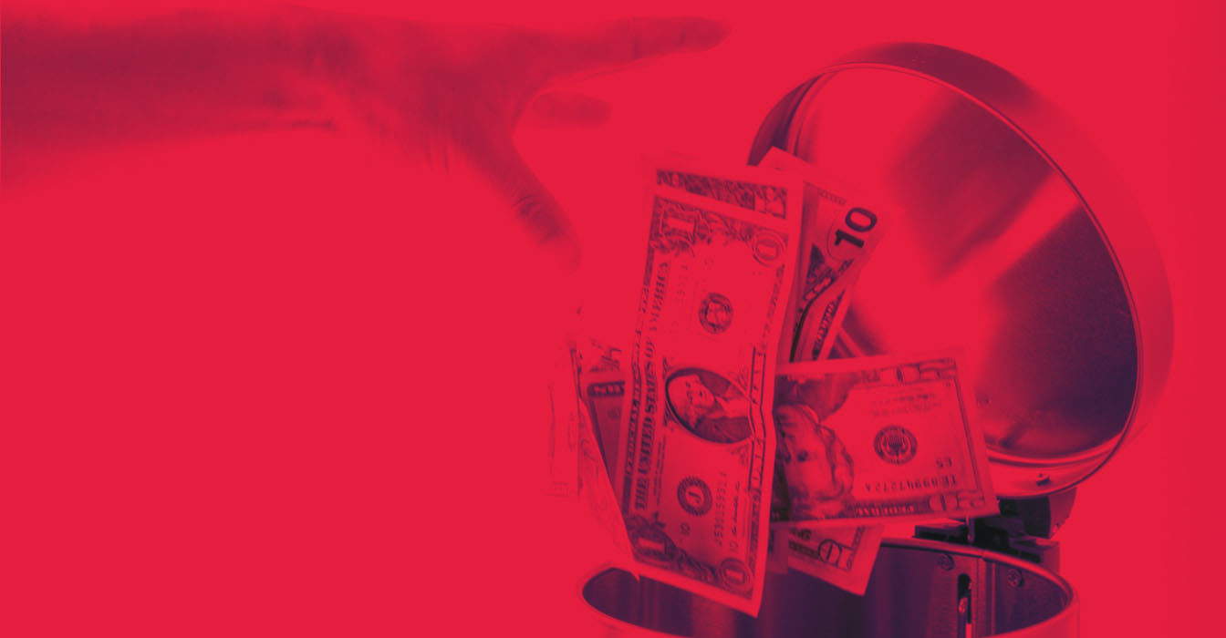Red image of hand throwing money into a garbage can